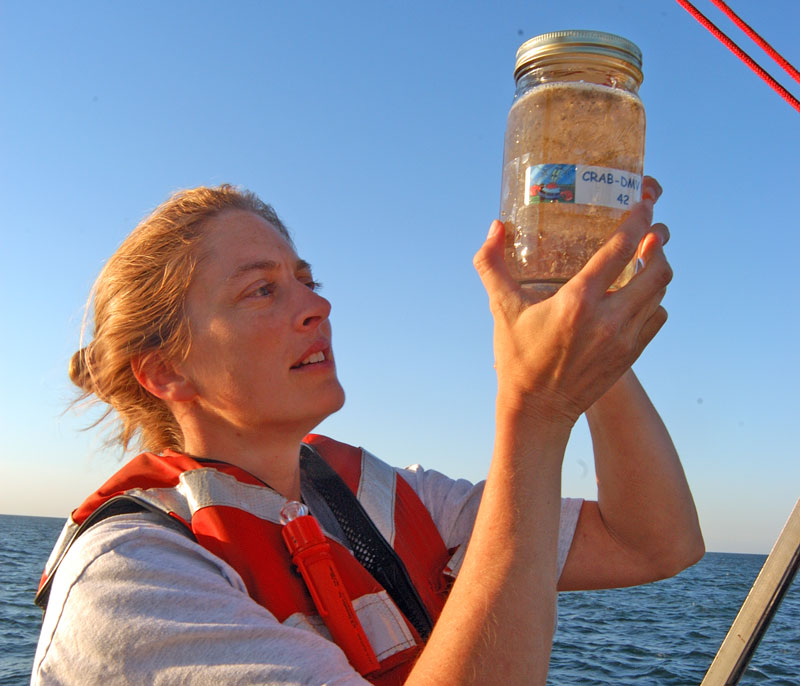 Elizabeth North with a jar of crab larvae