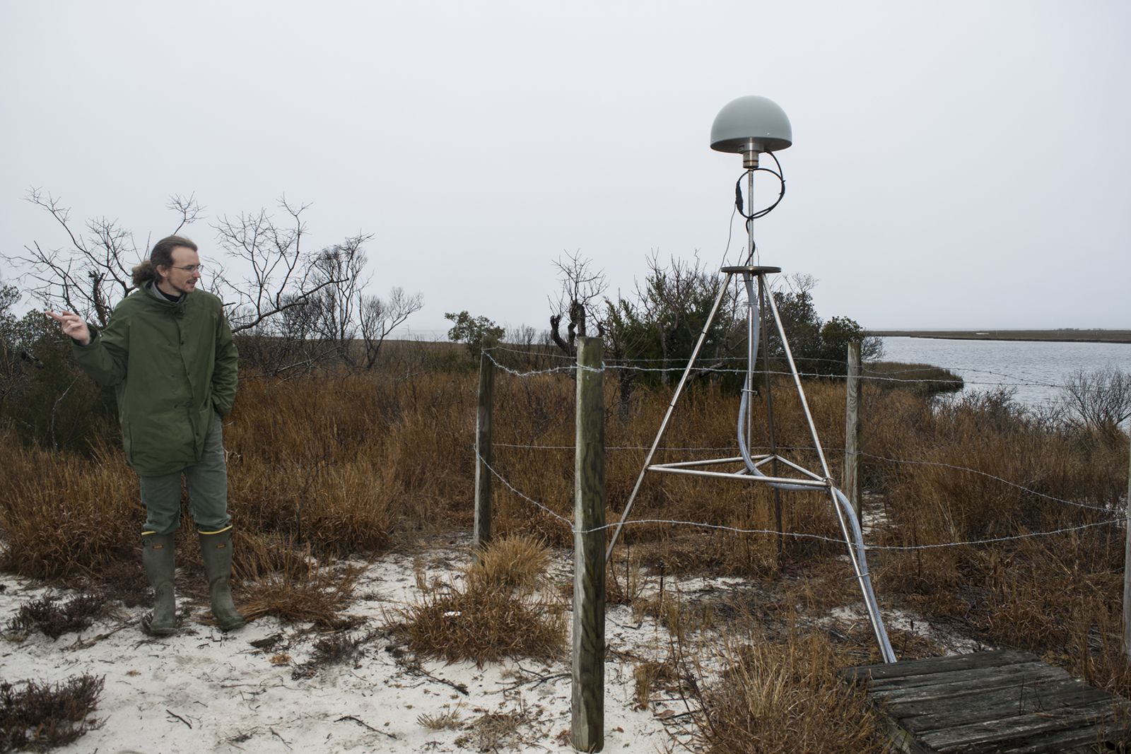 GIS specialist Neil Winn, next to GNSS CORS station in Assateague, Maryland. Photograph, Taryn Sudol