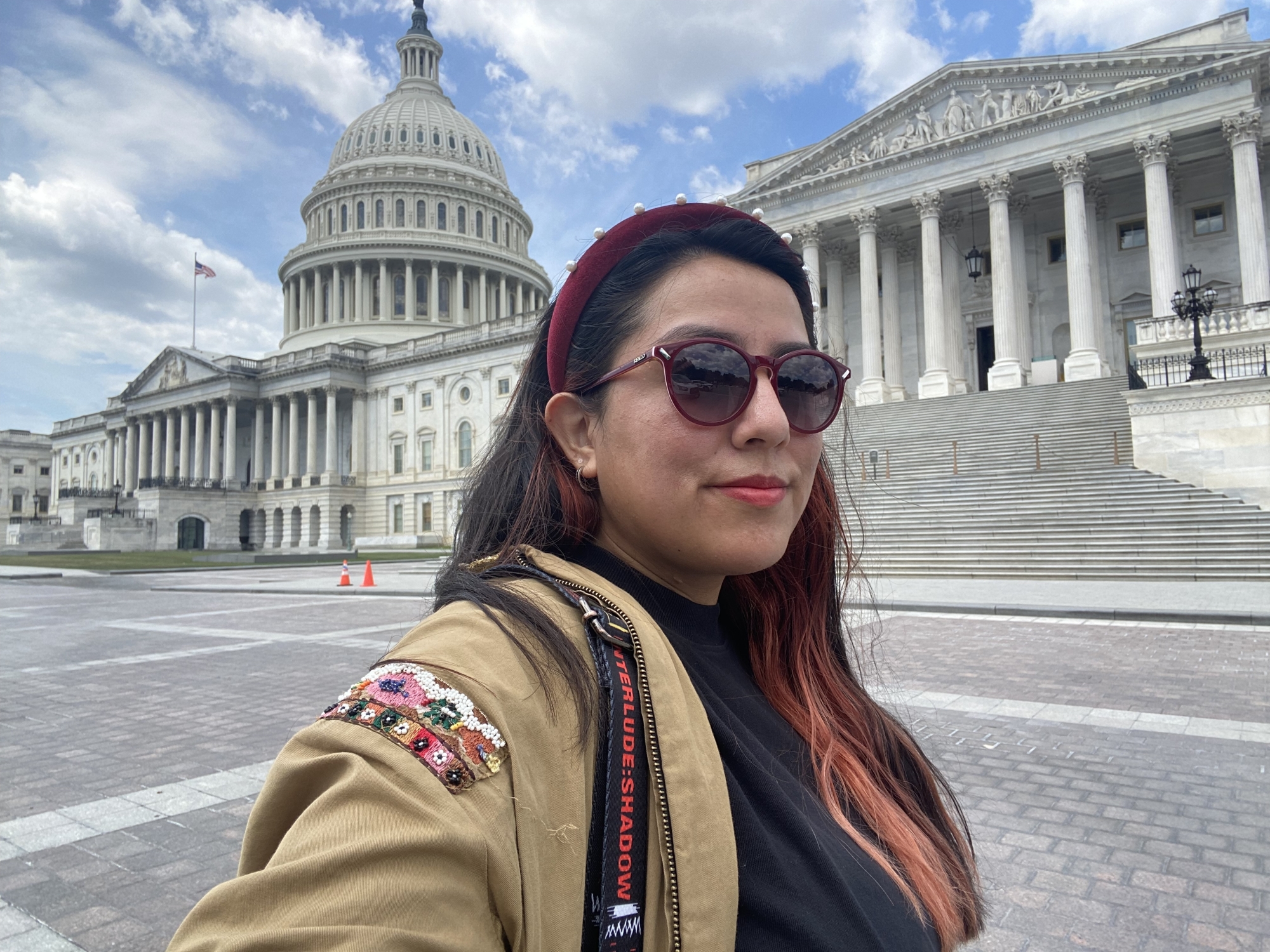 Paulina stands in front of a building in the capital.