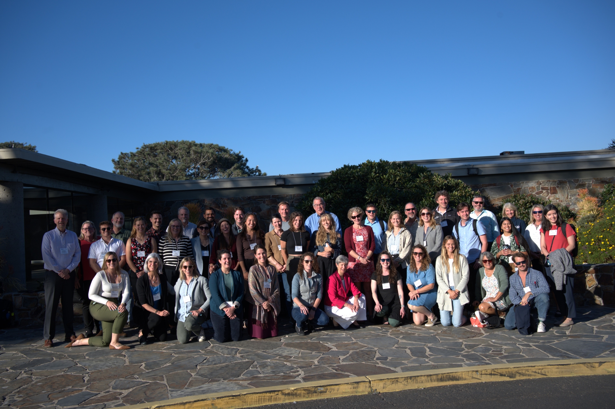 Three dozen workshop participants pose for an outdoor group photo.