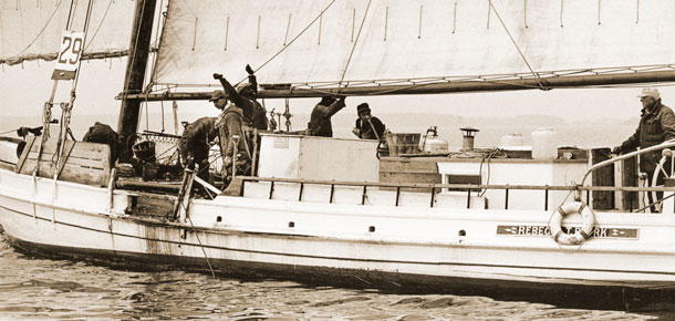 watermen on oyster dredgeboat under sail